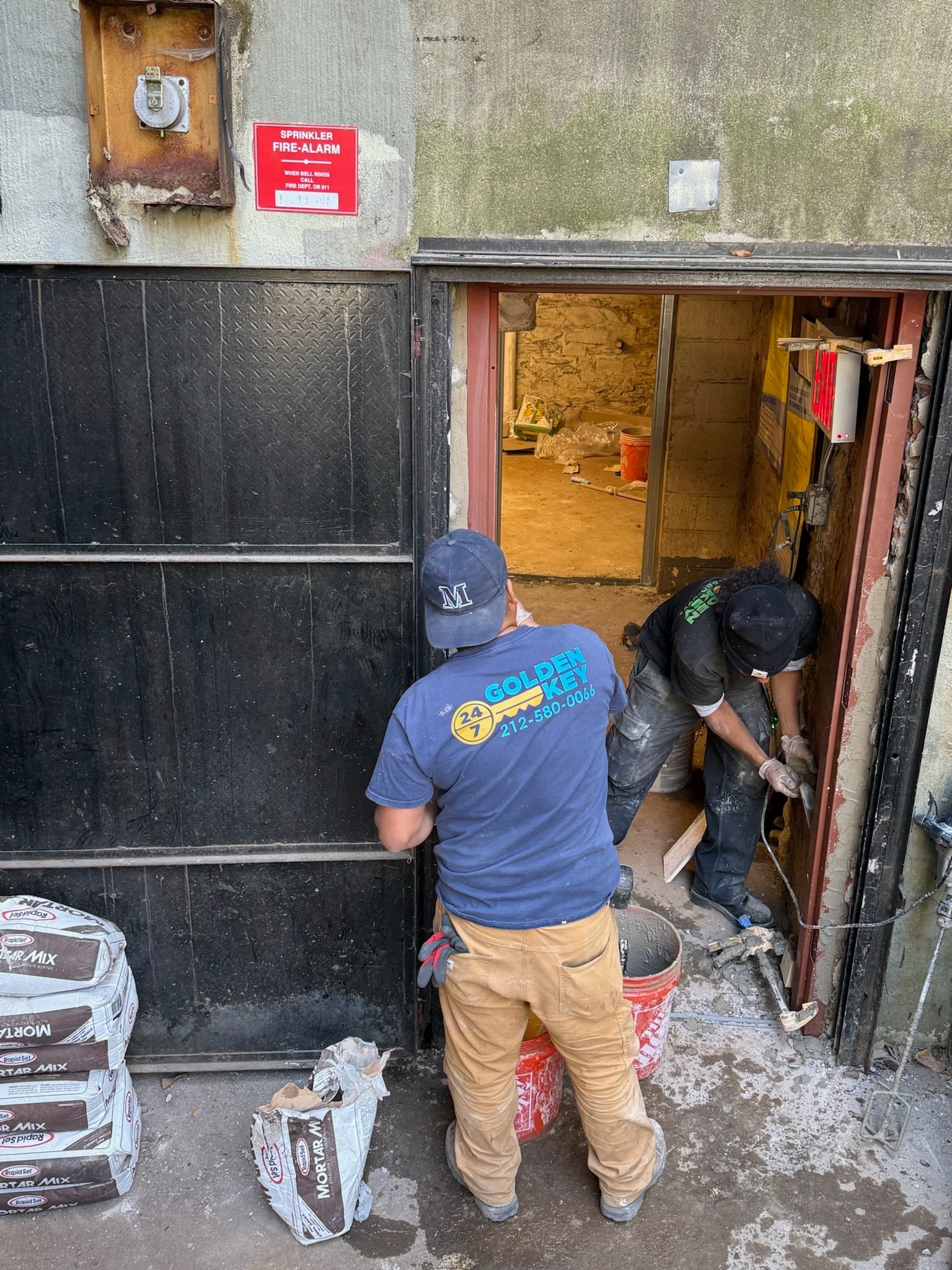 Golden Key Locksmith NYC crew performing door frame and threshold work in Brooklyn