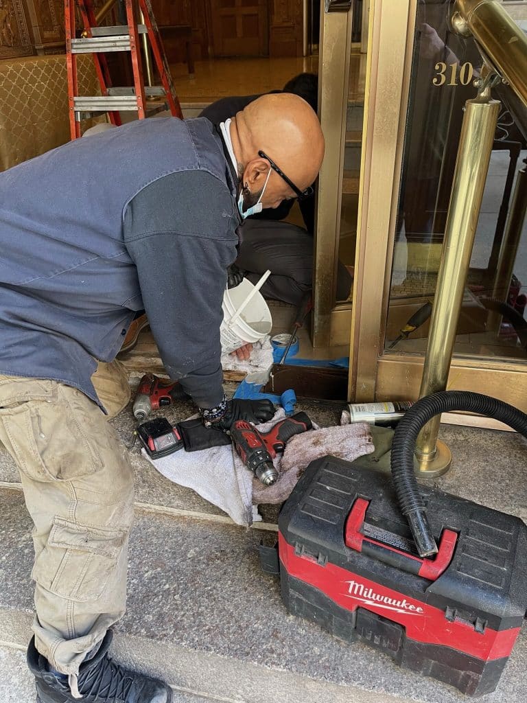 Golden Key Locksmith NYC certified technician servicing a commercial entrance at a pre-war apartment in Hells Kitchen, Manhattan
